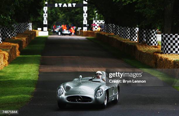 Stirling Moss of Great Britain drives up the hill in a Mercedes-Benz 300SLR at the Goodwood Festival of Speed on June 23, 2007 in Chichester, England.