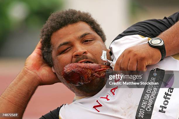 Reese Hoffa eats a turkey leg after winning the men's shot put on day three of the AT&T USA Outdoor Track and Field Championships at IU Michael A....