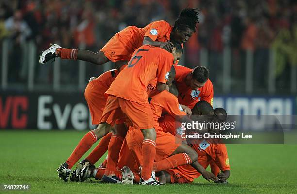 Maceo Rigters of Holland is mobbed by his team mates after he scores their third goal during the UEFA U21 Championship Final match between...