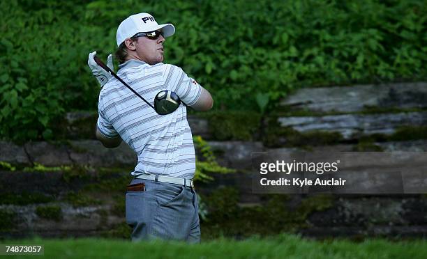 Hunter Mahan watches hiss tee shot on the 17th hole during the third round of the Travelers Championship at the TPC River Highlands June 23, 2007 in...