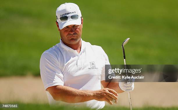 Jay Williamson reacts after his bunker shot on the fifth hole during the third round of the Travelers Championship at the TPC River Highlands June...