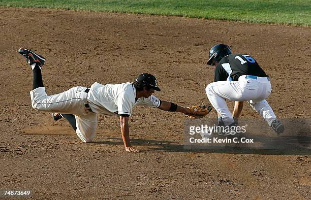 Tim Fedroff of the North Carolina Tar Heels slides safely into second base before a tag by second baseman Joey Wong of the Oregon State Beavers...
