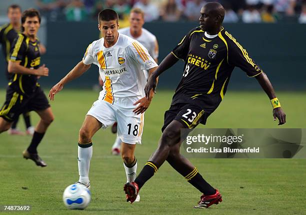 Kyle Martino of the Los Angeles Galaxy advances the ball against Ezra Hendrickson of the Columbus Crew at Home Depot Center on June 23, 2007 in...