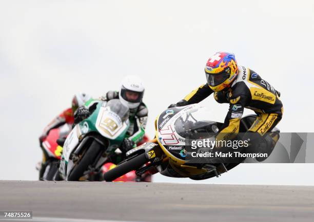 Dominique Aegerter of Switzerland and team Multimedia racing crashes out of the 125cc race at the Nickel & Dime British Moto GP at Donington Park on...