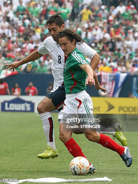 Chicago, UNITED STATES: Mexico's Jose Andres Guardado is challenged by Clint Dempsey of the US during the the CONCACAF Gold Cup final 24 June 2007 at...