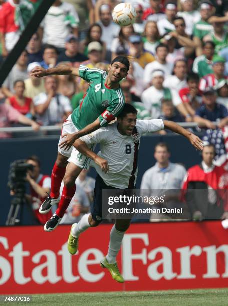 Rafael Marquez of Mexico heads the ball over Clint Dempsey of the USA during the CONCACAF Gold Cup Final match at Soldier Field on June 24, 2007 in...