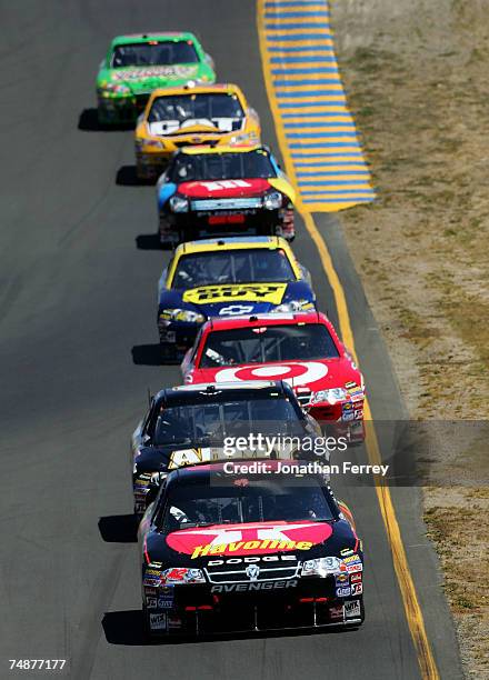 Juan Pablo Montoya, driver of the Texaco/Havoline Dodge, leads Regan Smith, driver of the U.S. Army Chevrolet, during the NASCAR Nextel Cup Series...