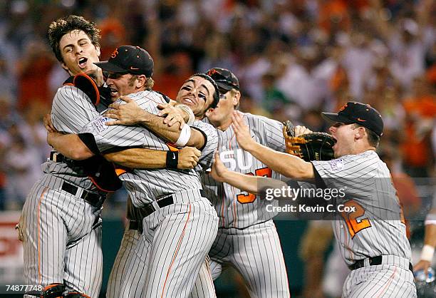 Closing pitcher Joe Paterson of the Oregon State Beavers is congratulated by teammates as they celebrate winning a second straight NCAA Championship...