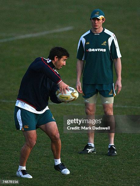 Former Rugby League player Andrew Johns instructs Stephen Larkham of the Wallabies during an Australian Wallabies training session at Xavier College...