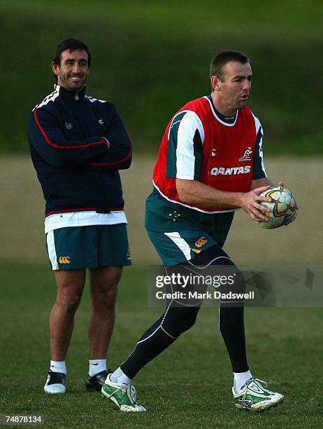 Chris Latham of the Wallabies practices his kicking under the watchful eye of former Rugby League player Andrew Johns during an Australian Wallabies...