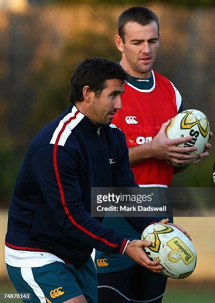 Chris Latham of the Wallabies watches the kicking technique of former Rugby League player Andrew Johns during an Australian Wallabies training...