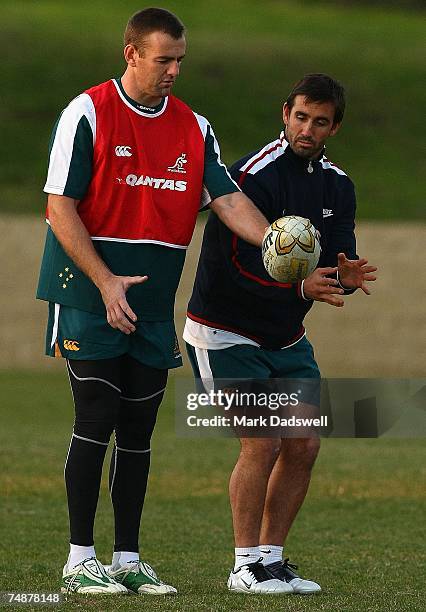 Chris Latham of the Wallabies receives advice from former Rugby League player Andrew Johns during an Australian Wallabies training session at Xavier...