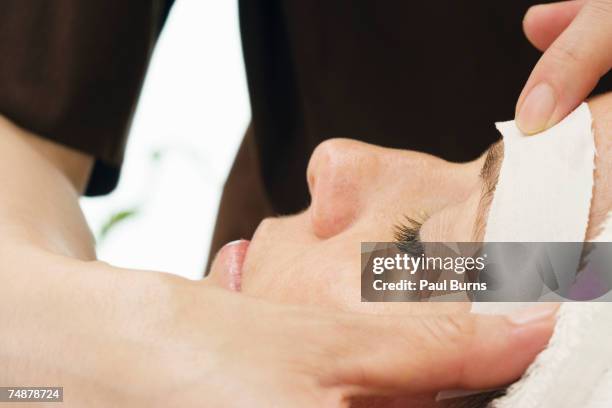 woman having eye brows waxed, close-up - eyebrow waxing stock pictures, royalty-free photos & images