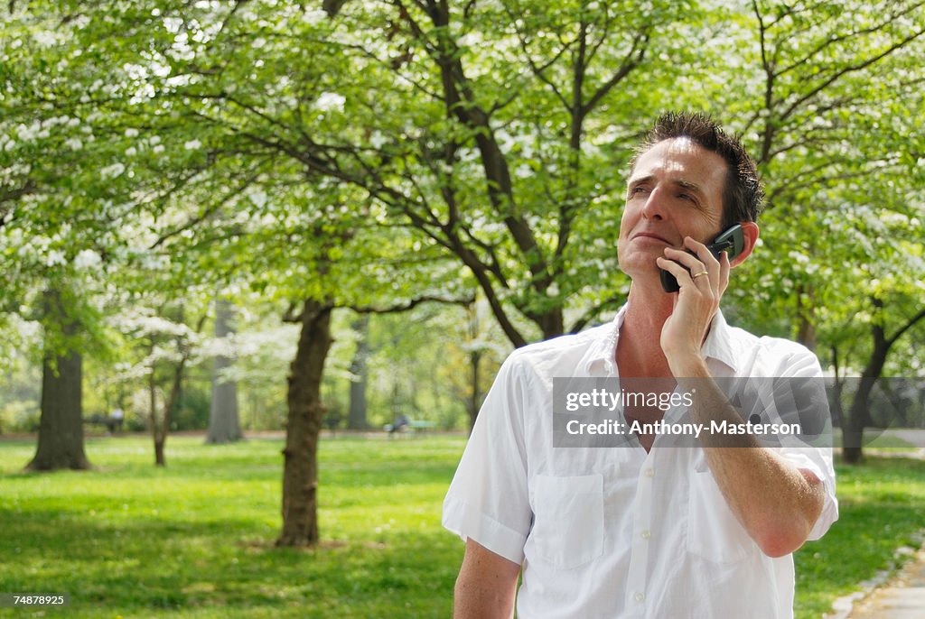 Mature man using mobile phone in park