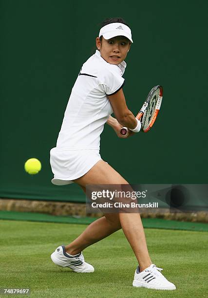 Aiko Nakamura of Japan hits a backhand during the Women's Singles first round match against Martina Sucha of Slovakia during day one of the Wimbledon...