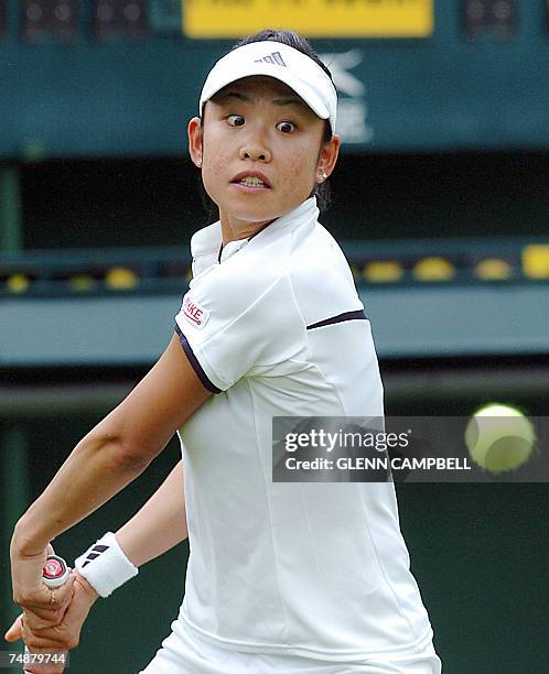 London, UNITED KINGDOM: Aiko Nakamura of Japan returns the ball to Martina Sucha of Slovakia during the first round of the Wimbledon Tennis...