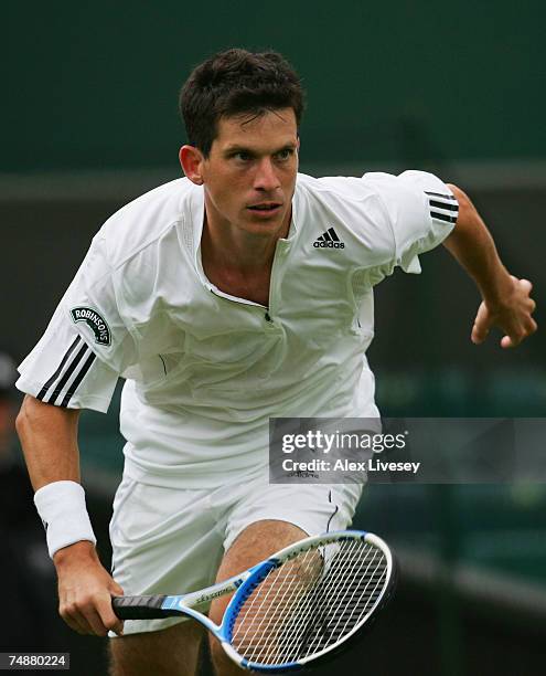 Tim Henman of Great Britain runs in to the net during his Men's Singles first round match against Carlos Moya of Spain during day one of the...