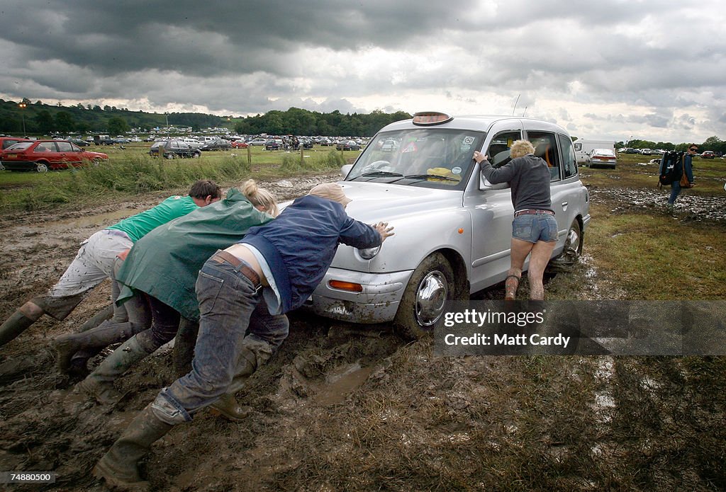 Festival Goers Depart From A Muddy Glastonbury