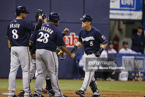 Ryan Braun, Prince Fielder, and Geoff Jenkins of the Milwaukee Brewers celebrate Jenkins' grand slam home run in a game against the Minnesota Twins...