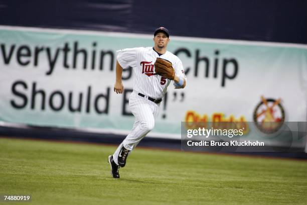 Michael Cuddyer of the Minnesota Twins runs for a foul ball in a game against the Milwaukee Brewers at the Humphrey Metrodome in Minneapolis,...
