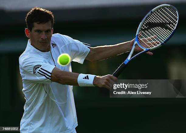 Tim Henman of Great Britain hits a backhand during his Men's Singles first round match against Carlos Moya of Spain during day one of the Wimbledon...