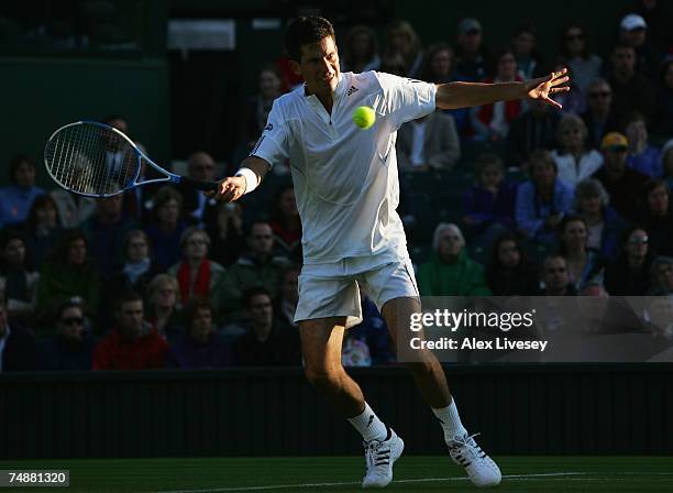 Tim Henman of Great Britain hits a forehand during his Men's Singles first round match against Carlos Moya of Spain during day one of the Wimbledon...