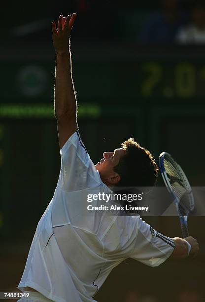 Tim Henman of Great Britain serves during his Men's Singles first round match against Carlos Moya of Spain during day one of the Wimbledon Lawn...