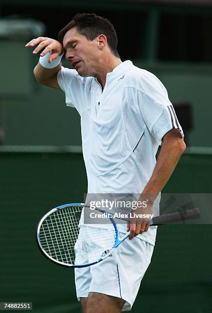 Tim Henman of Great Britain wipes his brow during his Men's Singles first round match against Carlos Moya of Spain during day one of the Wimbledon...