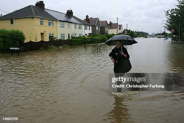 Stranded residents battle the flood waters in the village of North Cave, near Hull in northern England on 25 June Hull, England. Much of Britain was...