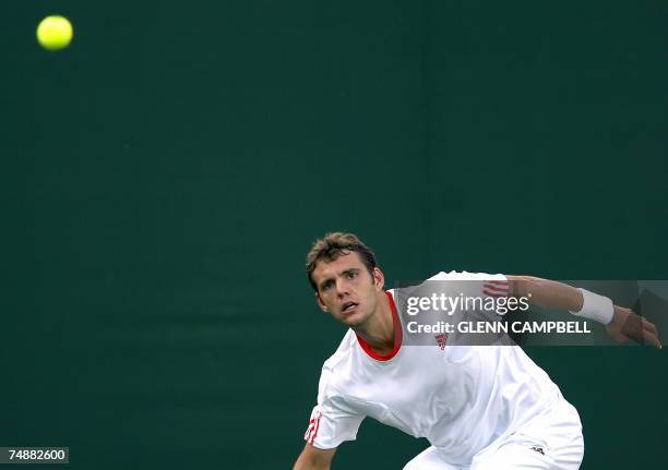 London, UNITED KINGDOM: Paul-Henri Mathieu of France looks at the ball as he returns the ball to Radek Stepanek of Czech Republic during the first...