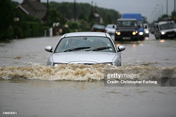 Stranded cars and residents battle the flood waters in the village of North Cave, near Hull in northern England on 25 June Hull, England. Much of...