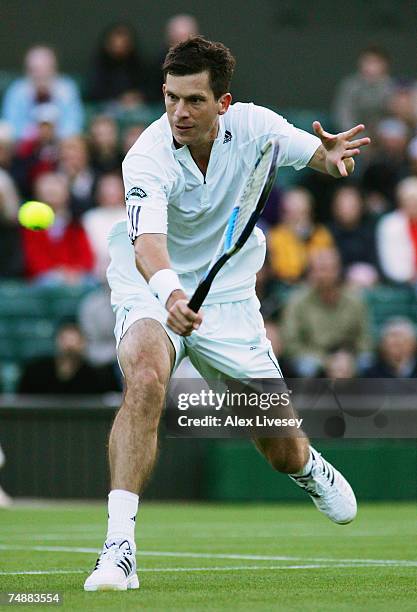 Tim Henman of Great Britain hits a backhand during his Men's Singles first round match against Carlos Moya of Spain during day one of the Wimbledon...