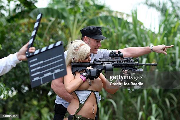 Jason Atkins, creator/producer, shows Andrea Brooke Ownbey the target she should shoot at on the set of Girls and Guns, a web-based reality show...