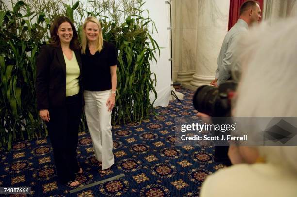 Elissa Levin, an aide to Rep. Tammy Baldwin, D-Wis., and Anne Steckel, of the American Farm Bureau Federation, have their photo taken in front of a...