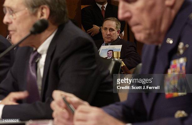 Bruce DeCell of Staten Island, whose son-in-law Mark Petrocelli died in the attack on the World Trade Center, looks on as Defense Secretary Donald...