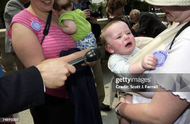 Ten-month-old Joshua Speich, with mom, Christie, of Laurel, Md., provides a sound byte for Public Radio International during a "nurse-in" hosted by...