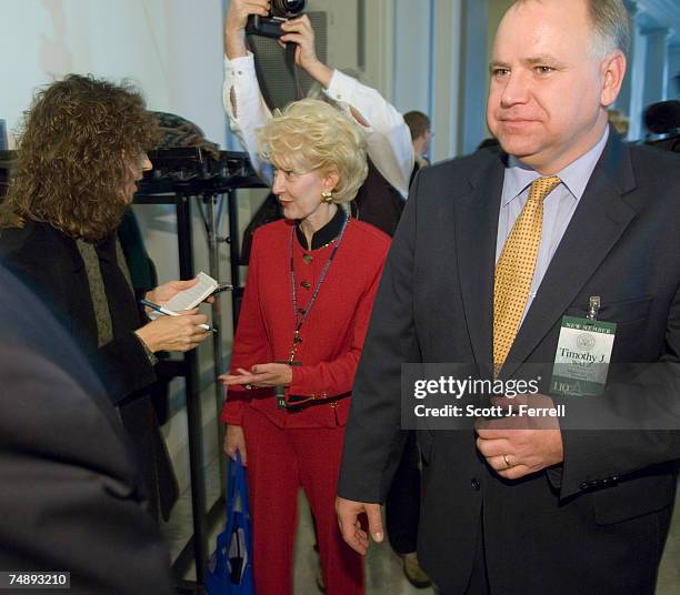 Rep.-Elect Tim Walz , walks by Democratic banker Christine Jennings, in red, who trails Republican car dealer Vern Buchanan by 373 votes in the...