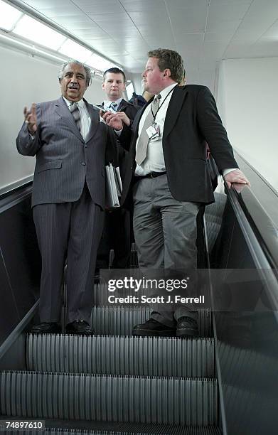 House Ways and Means Chairman Charles B. Rangel, D-N.Y., talks to reporters, on the escalator from the Longworth House Office Building, after the...