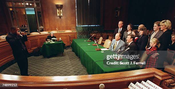 Richard W. Story, nominee to be U.S. District Judge for the Northern District of Georgia, seated with Sen. Max Cleland, D-Ga., and Story's family and...