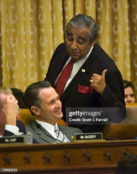 Ranking Democrat Charles B. Rangel, D-N.Y., talks with Wally Herger, R-Calif., during the House Ways and Means markup of the draft bill, Fiscal 2006...