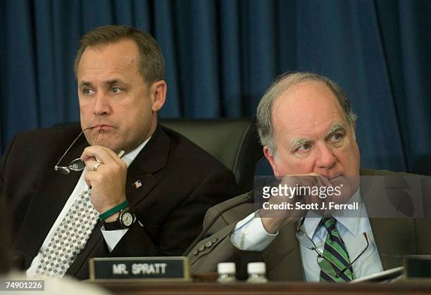 Chairman Jim Nussle, R-Iowa, and ranking Democrat John M. Spratt Jr., D-S.C., chew on their glasses during the House Budget markup of the Fiscal 2006...