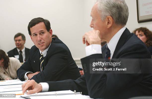 Sen. Rick Santorum, R-Pa., and Chairman Orrin G. Hatch, R-Utah, talk as they wait for House and Senate conferees to meet to consider legislation that...