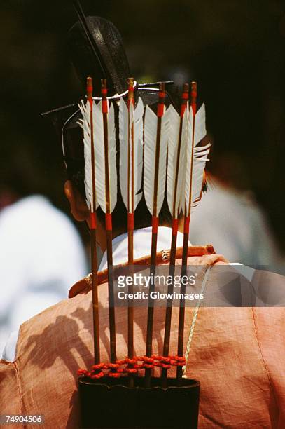 rear view of a person carrying a quiver with arrows on his shoulders, hollyhock festival, kyoto prefecture, japan - archery feather stockfoto's en -beelden