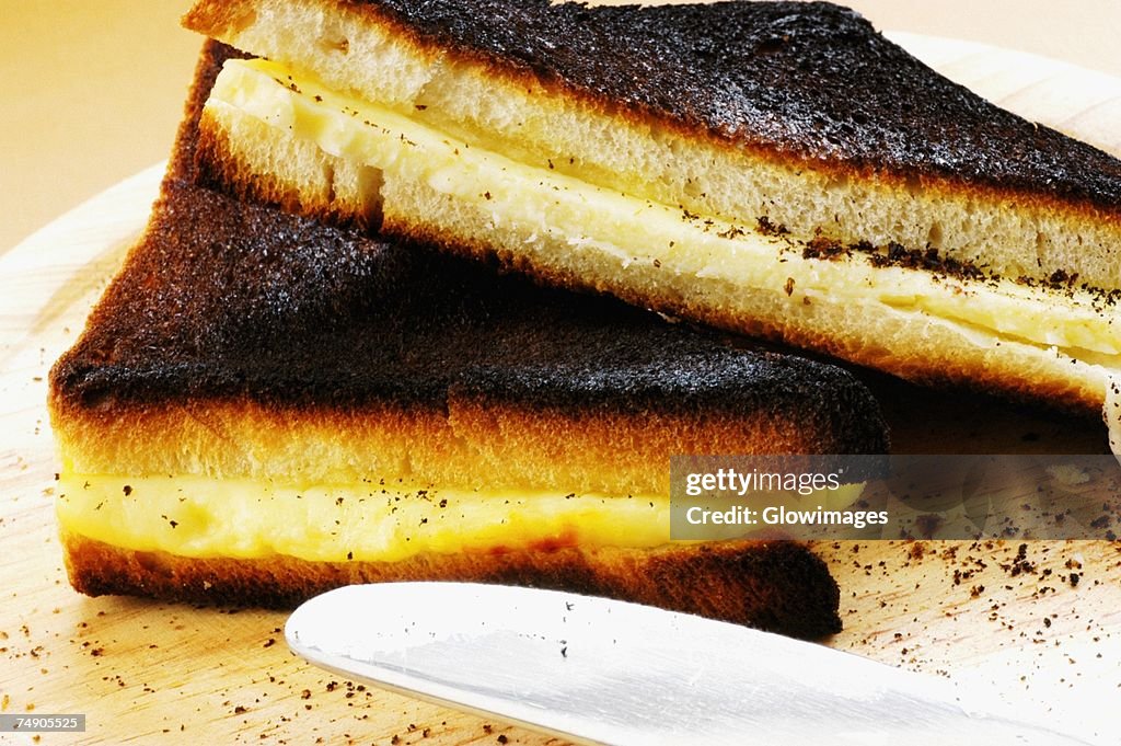 Close-up of two toasts with a table knife