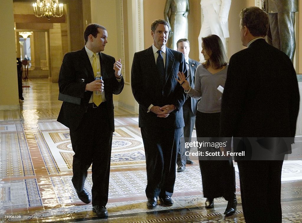 Huncoat Senator FRIST--Senate Majority Leader Bill Frist, R-Tenn., talks to aides as ...
