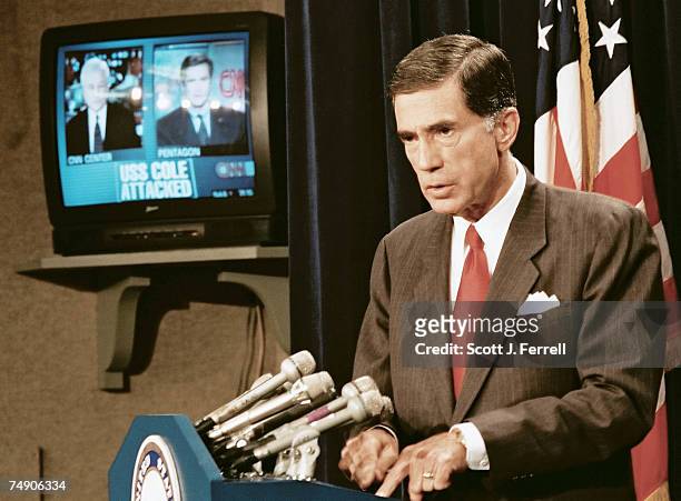 Broadcasts in the background as Senate Armed Services member Charles Robb, D-Va., speaks during a news conference in the Senate Radio/TV Gallery...