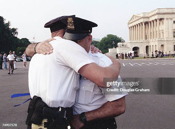 Capitol Police officer T.J. Wissemann hugs fellow officer S.I. Flax to console him.Flax had become emotional after the bodies of U.S. Capitol Police...