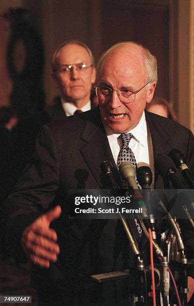 Sen. Larry E. Craig, R-Idaho, background, and Vice President Richard B. Cheney during a news conference on the GOP tax cut plan.