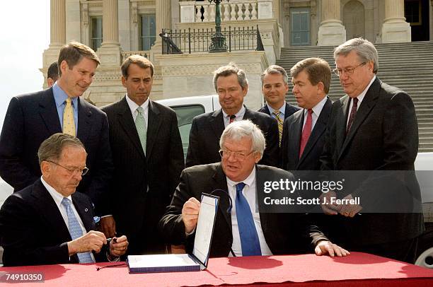 Sen. Ted Stevens, R-Alaska, who is the Senate's President Pro Tempore, and House Speaker J. Dennis Hastert, R-Ill., sign a $70 billion tax cut...