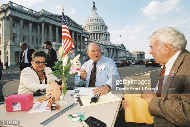 Gary L. Ackerman, D-N.Y., middle, at a card table he and his staff set up near the East Front steps on the House side of the U.S. Capitol because his...